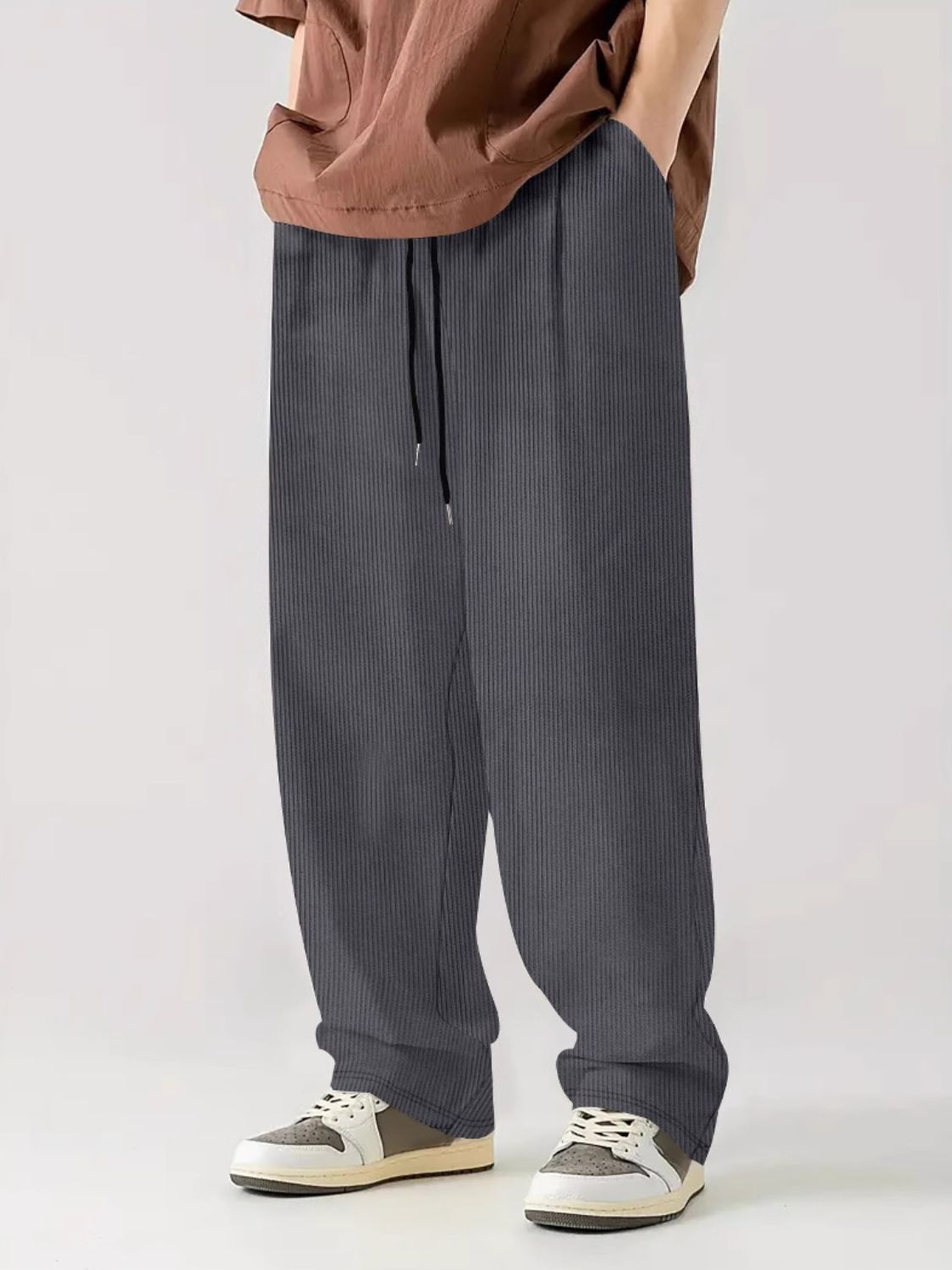 Wide-leg drawstring pants with side pockets and a drawstring waist.