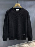 Long sleeve textured sweatshirt with a round neckline.